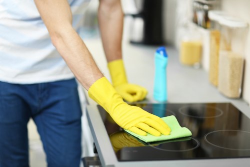 Technician carrying out carpet cleaning with precautions